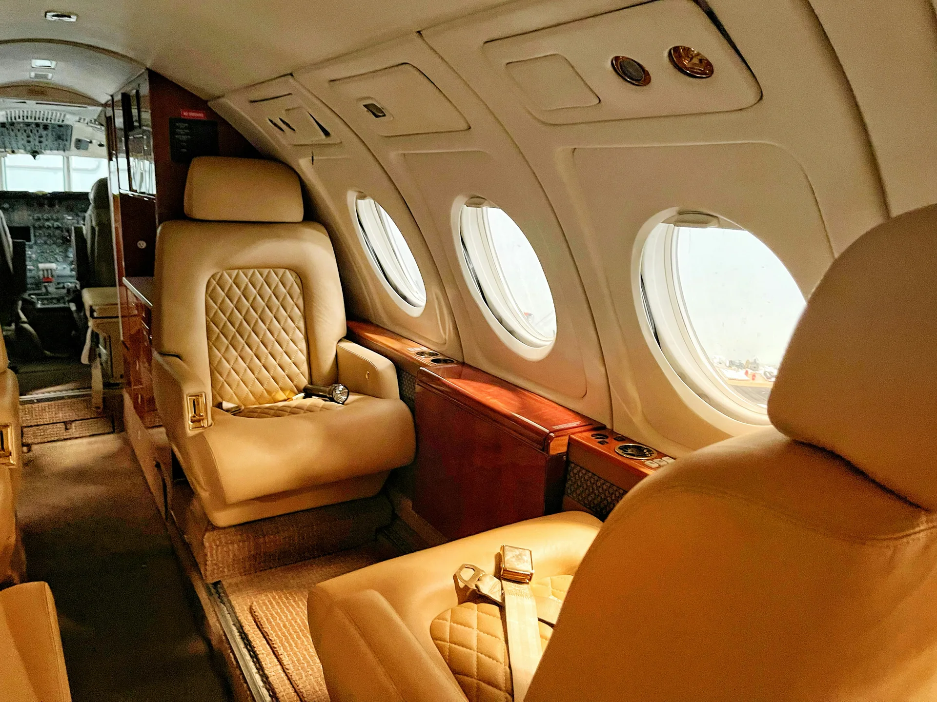 Premium private jets parked inside a spacious, modern aircraft hangar
